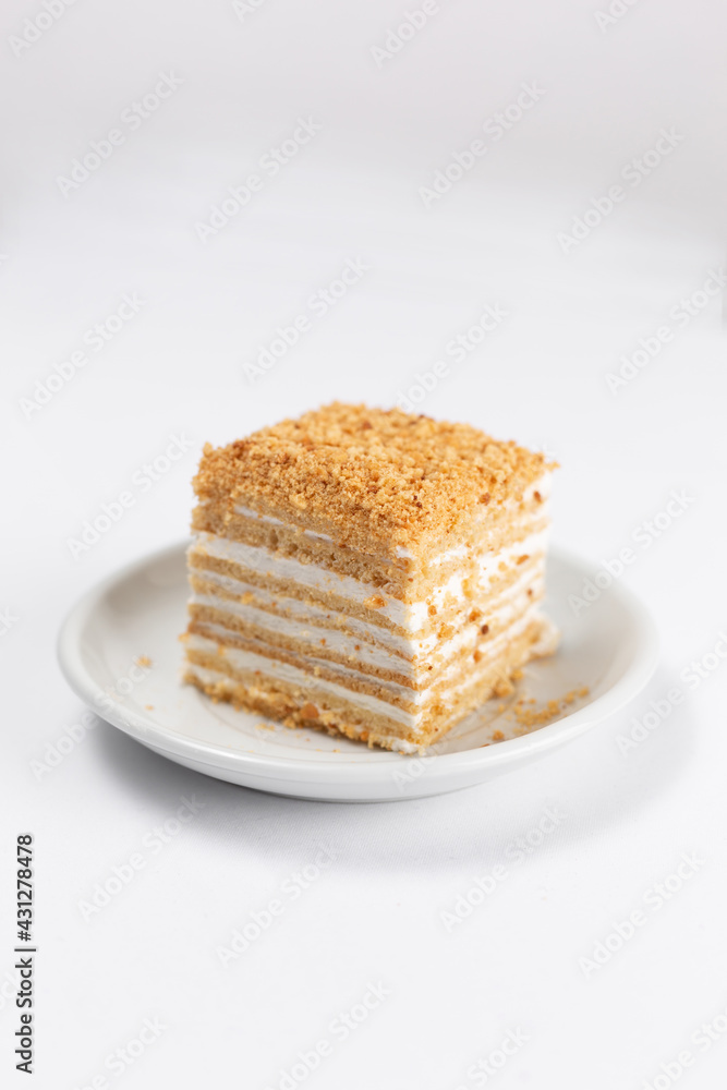 Slice of honey cake on white background