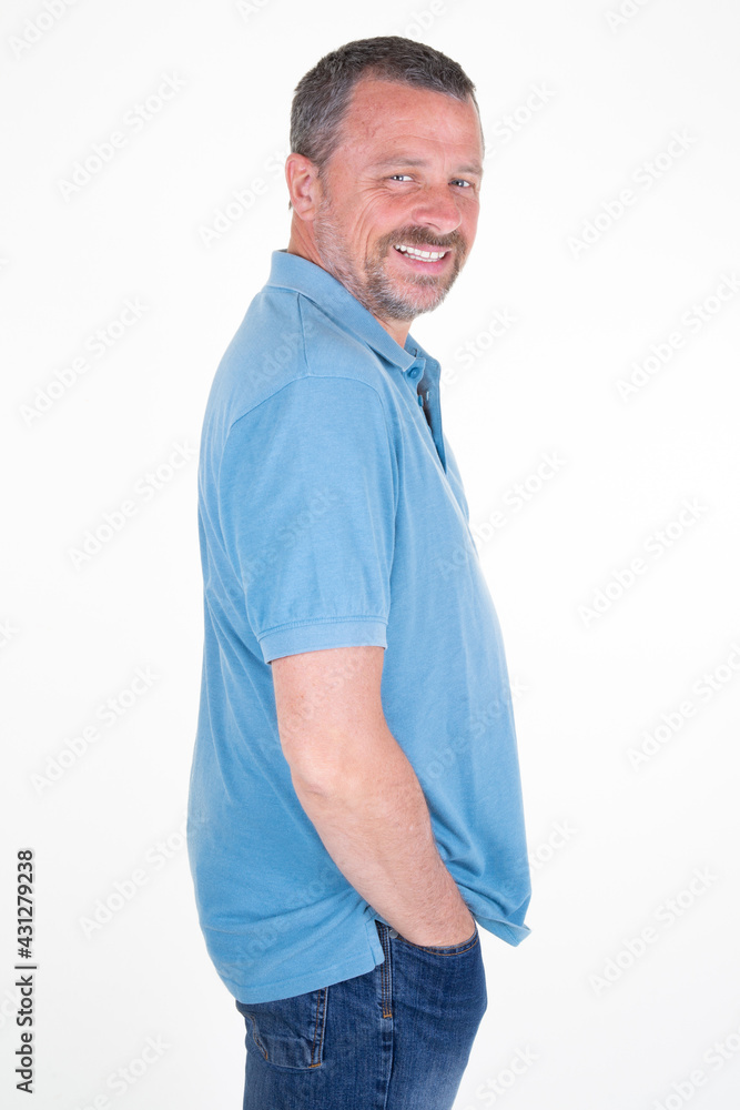 Portrait of happy handsome middle aged man side rear view beard gray hair smiling in white background Portrait of happy handsome middle aged man side rear view beard gray hair smiling in white background