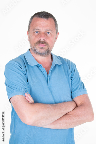 Portrait of handsome mature man arms crossed on white background © OceanProd