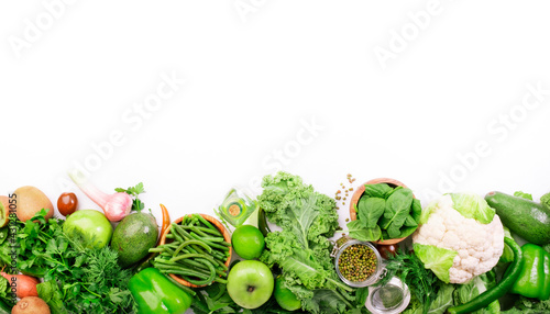 Fototapeta Naklejka Na Ścianę i Meble -  Green vegetables, herbs, beans and fruits. Healthy clean eating: leaf vegetables, seeds, superfoods on white background, vegetarian protein source and detox diet nutrition