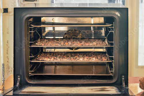 cocoa beans roasting in an oven, aromatic raw food