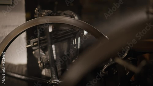 Old, rusty gears spinning in a historical workshop. Engineering, metal machinery. Book shop, antique workshop. Original hobby, letterpress studio.