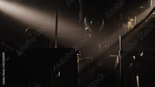 Old machinery, vintage letterpress studio, book production. Industrial scene, gears spinning in a workshop in slow motion. Historical machines, book making, artistic hobby.