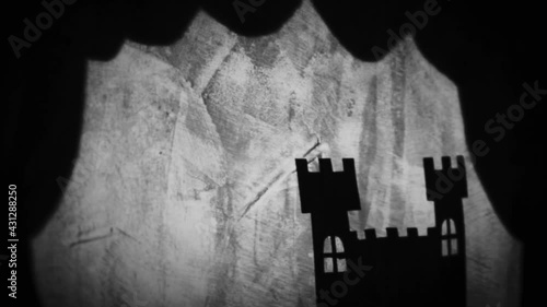 Vintage animation, shadow theatre on a wall. Pantomime, fantasy story. Halloween scene, black and white storytelling. Classic fable for children, creepy puppets.