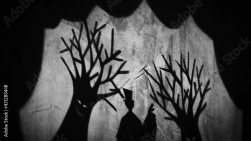 Vintage animation, shadow theatre on a wall. Pantomime, fantasy story. Halloween scene, black and white storytelling. Classic fable for children, creepy puppets.