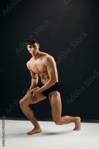 male bodybuilder with muscular body black panties studio