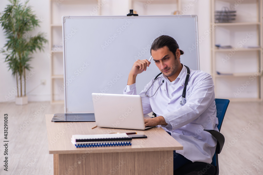 Young male doctor in telemedicine concept Young male doctor in telemedicine concept