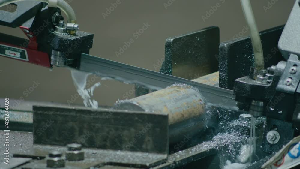 heavy industry, a machine with an electric saw cuts metal rods for further production of parts from them heavy industry, a machine with an electric saw cuts metal rods for further production of parts from them