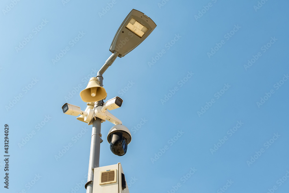 Cluster of security cameras on a lamppost, in an public Park on the sky background, with copy space. Cluster of security cameras on a lamppost, in an public Park on the sky background, with copy space.