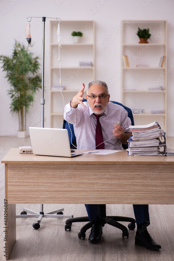 Old male employee in blood transfusion concept Old male employee in blood transfusion concept