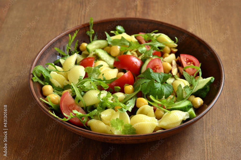 Mediterranean pasta salad with vegetables and chickpeas, copy space