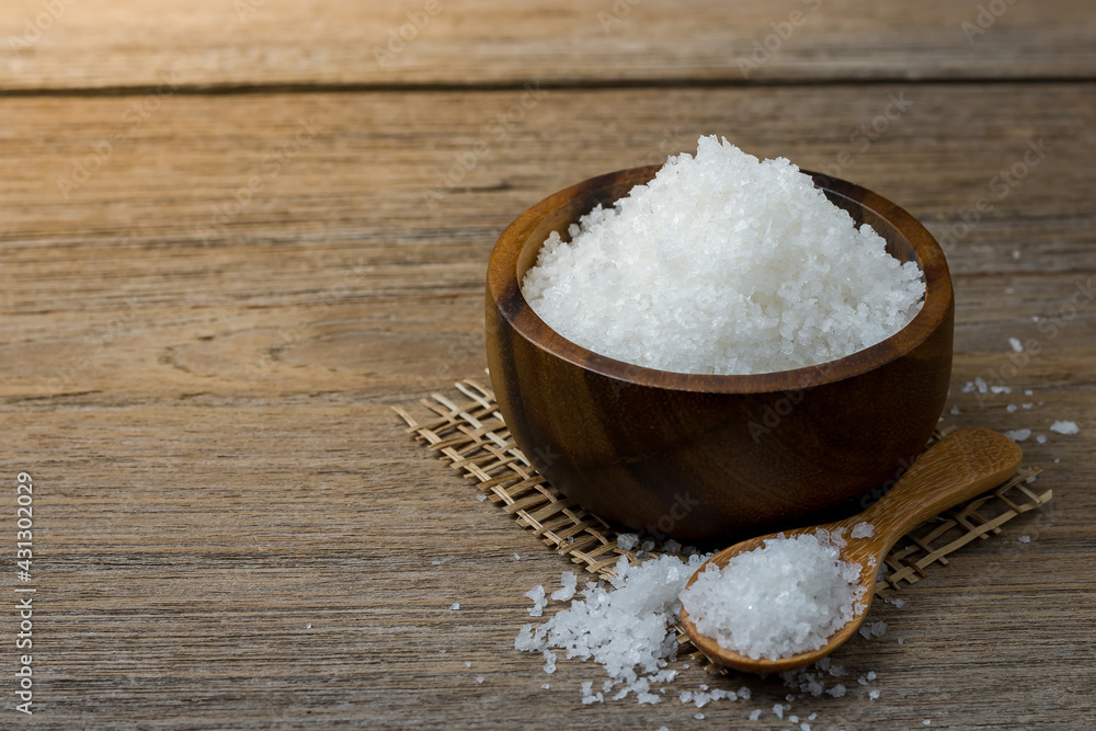 Natural salt in a wooden cup On the wooden table Ready to cook. Natural salt in a wooden cup On the wooden table Ready to cook.