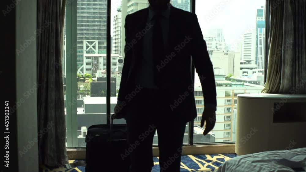 Businessman with suitcase leaving hotel room Businessman with suitcase leaving hotel room