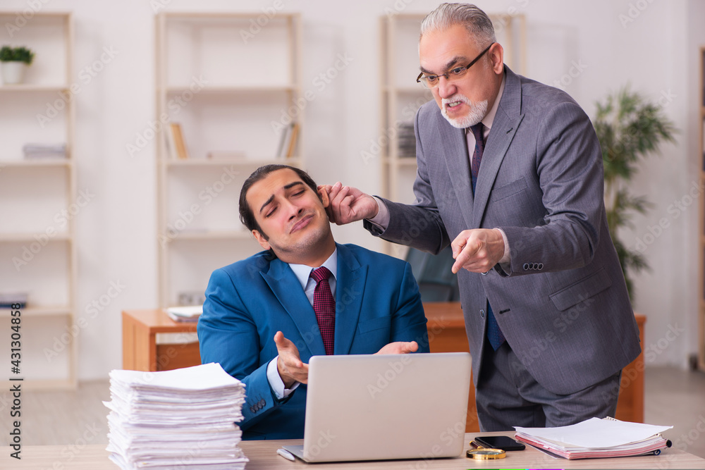 Two employees working in the office Two employees working in the office