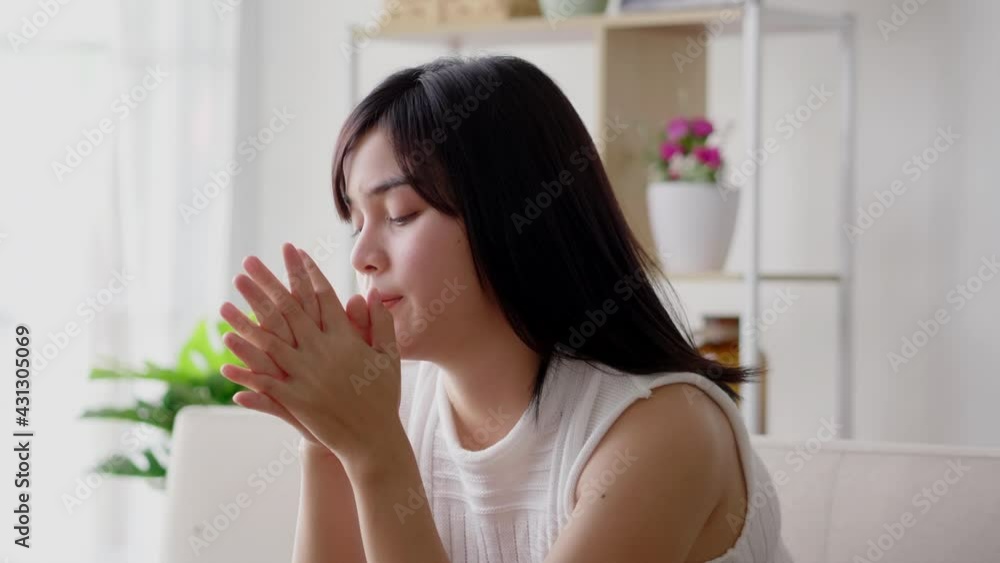 Sadness Asian woman serious alone sitting on indoor sofa in casual dress on morning. Stress lonely female unhappy thinking at home Sadness Asian woman serious alone sitting on indoor sofa in casual dress on morning. Stress lonely female unhappy thinking at home