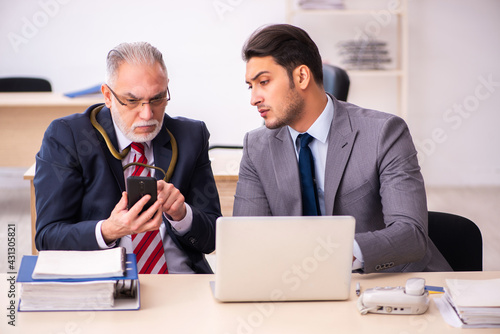 Old male boss holding snake on his neck