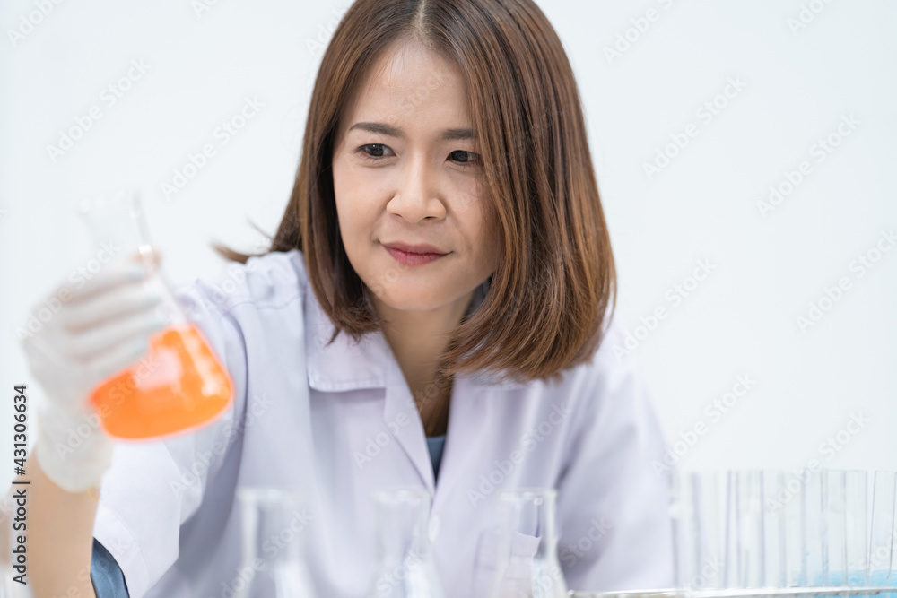 A young woman researcher, doctor, scientist, or laboratory assistant working with plastic medical tubes to research, examine scientific experiments in a modern laboratory. Education stock photo A young woman researcher, doctor, scientist, or laboratory assistant working with plastic medical tubes to research, examine scientific experiments in a modern laboratory. Education stock photo