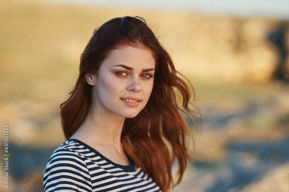 happy woman in striped t-shirt outdoors smiling happy woman in striped t-shirt outdoors smiling
