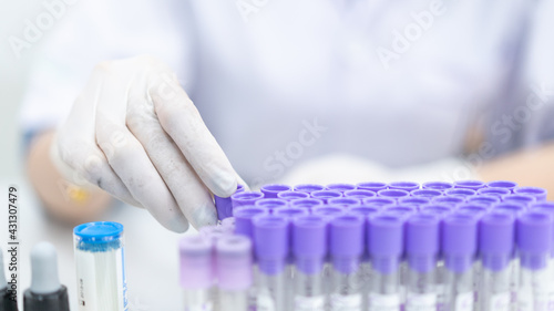 Canvastavla A young woman researcher, doctor, scientist, or laboratory assistant working with plastic medical tubes to research, examine scientific experiments in a modern laboratory