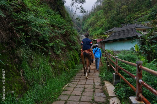 Semarang, December 6, 2020; Tourists on horseback exploring the Gedung Songo temple in Bandungan, Ungaran. Indonesia photo