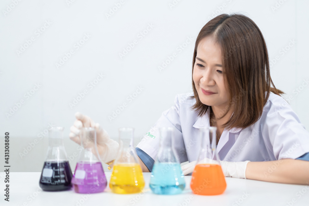 A young woman researcher, doctor, scientist, or laboratory assistant working with plastic medical tubes to research, examine scientific experiments in a modern laboratory. Education stock photo A young woman researcher, doctor, scientist, or laboratory assistant working with plastic medical tubes to research, examine scientific experiments in a modern laboratory. Education stock photo