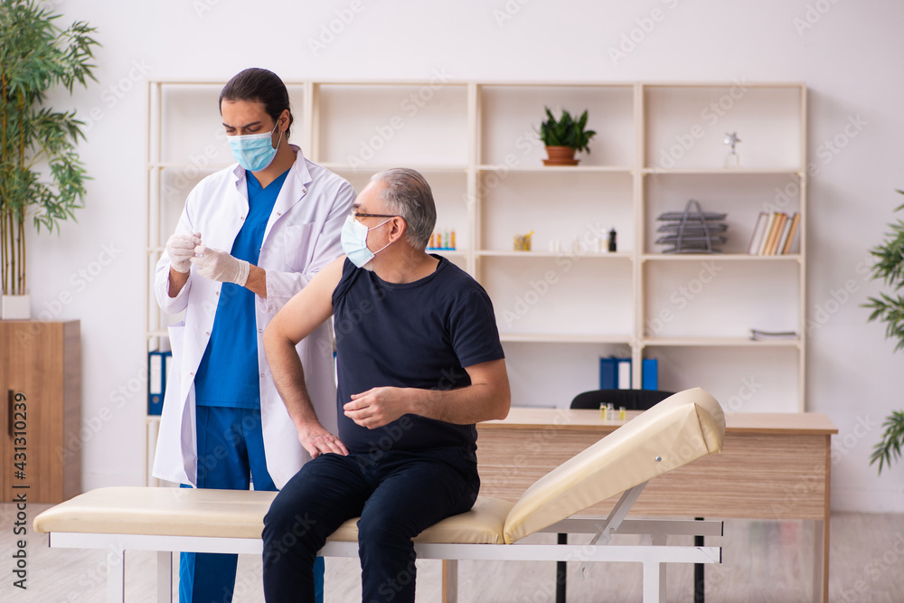 Old man visiting young doctor in covid-19 vaccination concept Old man visiting young doctor in covid-19 vaccination concept
