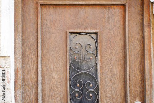 Old massive door with decorative door handle and lock, all still functional
