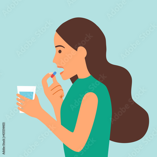 Woman taking medicine for illness treatment. Female take vitamin or supplement capsule pill with water.
