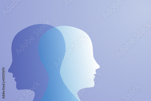 A metaphor for mental bipolar disorder. Two-faced. Split personality. The concept of mood disorder. The concept of dual personality. 2 The silhouette of the head on a blue gradient background. Mental  © Natali