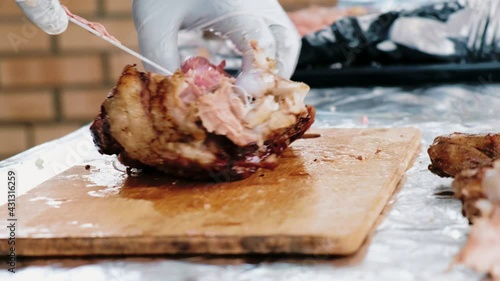 Cook cuts spiced meat into thin slices