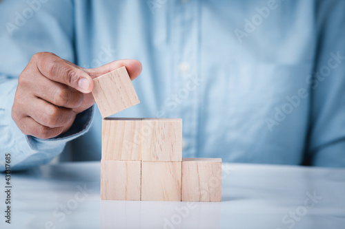 Business hand holding wooden block blank cubes creative idea on table, conceptual development business strategy  success background.
