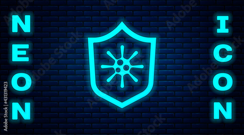 Glowing neon Shield protecting from virus, germs and bacteria icon isolated on brick wall background. Immune system concept. Corona virus 2019-nCoV. Vector