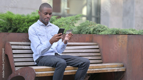 African Man making Successful Online Payment on Smartphone 