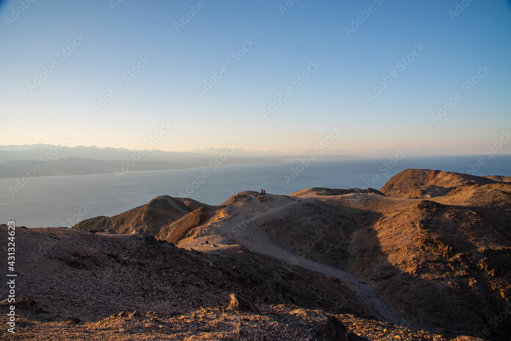 Arid desert mountains against the backdrop of the Red Sea. Shlomo mountain, Eilat Israel. Morning Daylight . High quality photo Arid desert mountains against the backdrop of the Red Sea. Shlomo mountain, Eilat Israel. Morning Daylight . High quality photo