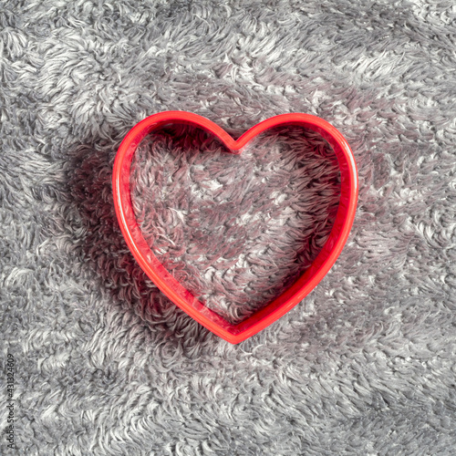 Red heart on fluffy fur blanket. Minimal background for Mother s Day and Valentine s Day.