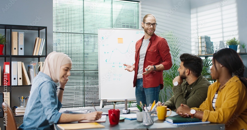 Young multinational group of office workers are brainstorming and looking for solution to problem. Teamwork in modern company. Young multinational group of office workers are brainstorming and looking for solution to problem. Teamwork in modern company.