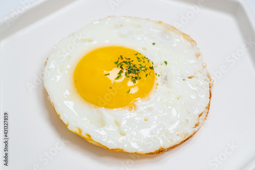 sprinkled with parsley powder fried egg with white background