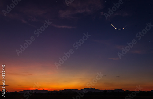 Foto Crescent  moon sky on dark blue dusk in the evening with sunset and beautiful su