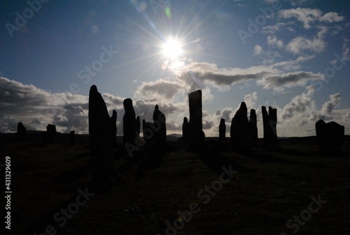 Silhouettes of the 5,000 years old Neolithic era Callanish Stones on sunset near the village of Callanish (Calanais) on the west coast of Lewis in the Outer Hebrides, Scotland, UK