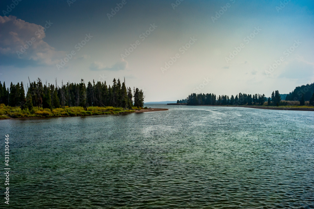 View of Yellowstone River with smoky sky from the Fishing Bridge in Yellowstone