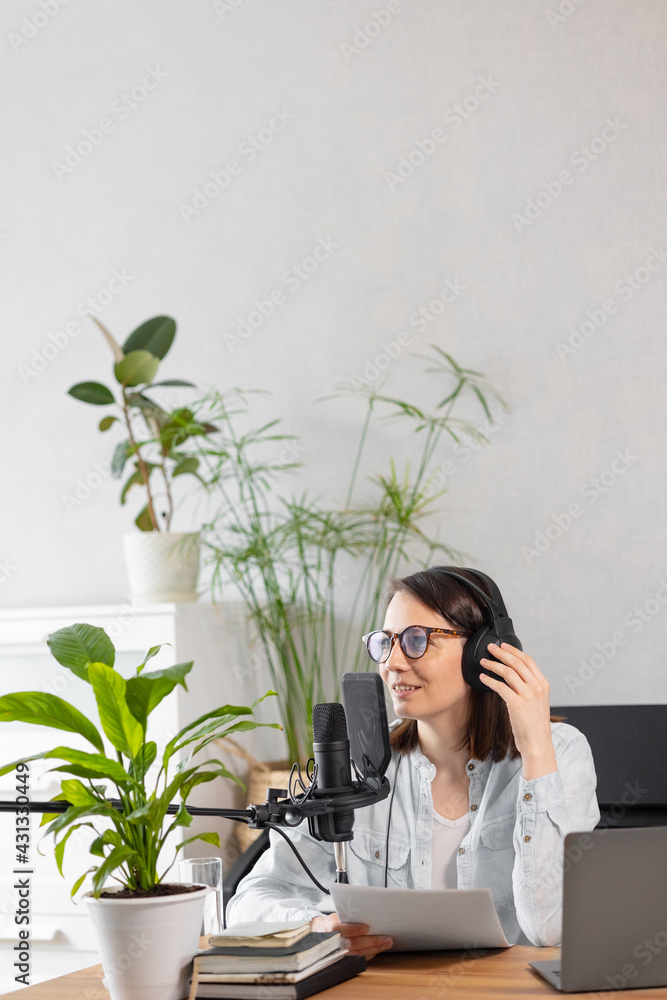 podcast, audio content creation. a beautiful European woman podcaster or radio host records a podcast or content in a recording studio. a Caucasian woman with a microphone and headphones records a podcast, audio content creation. a beautiful European woman podcaster or radio host records a podcast or content in a recording studio. a Caucasian woman with a microphone and headphones records a