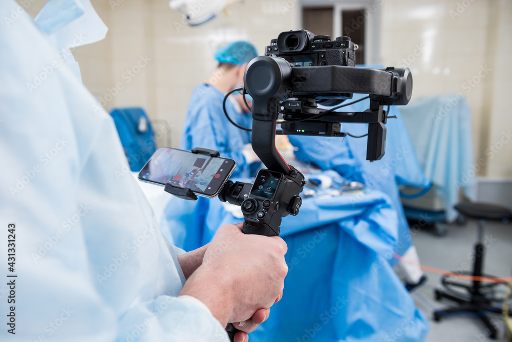 The videographer shoot the surgeon and assistants in the operating room with surgical equipment The videographer shoot the surgeon and assistants in the operating room with surgical equipment