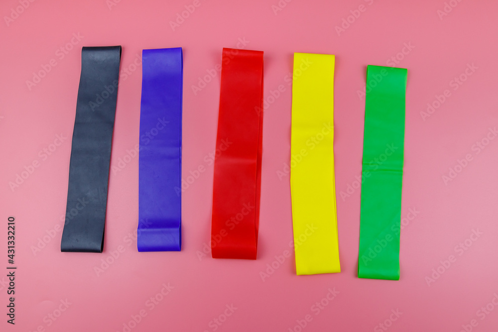 Set of elastic rubber bands for fitness on a pink background. Top view Set of elastic rubber bands for fitness on a pink background. Top view