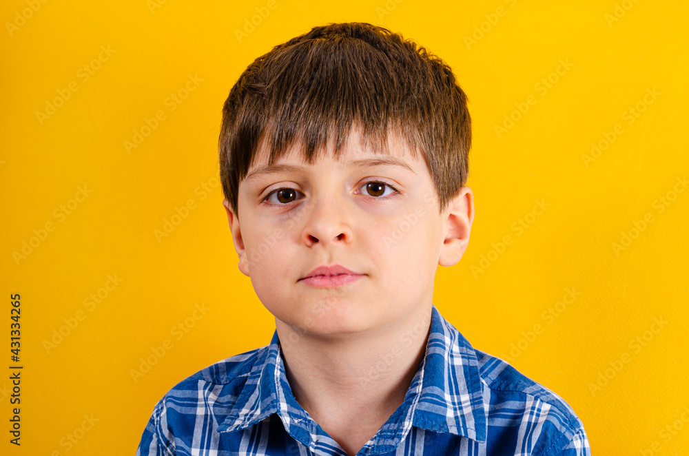 Cute boy looking at front on yellow background Cute boy looking at front on yellow background