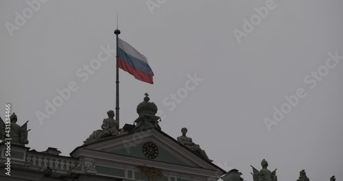 flag of the russian federation on the roof of the hermitage in cloudy weather