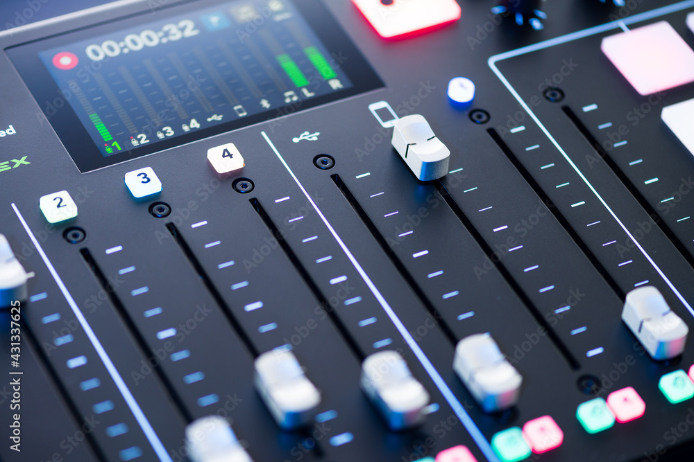 Professional podcast mixing console with faders and adjusting buttons, Audio sound mixer console. Sound mixing desk. Music mixer control panel in recording studio. podca mixer control broadcasting Professional podcast mixing console with faders and adjusting buttons, Audio sound mixer console. Sound mixing desk. Music mixer control panel in recording studio. podca mixer control broadcasting