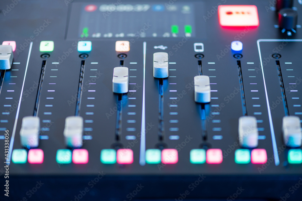 Professional podcast mixing console with faders and adjusting buttons, Audio sound mixer console. Sound mixing desk. Music mixer control panel in recording studio. podca mixer control broadcasting Professional podcast mixing console with faders and adjusting buttons, Audio sound mixer console. Sound mixing desk. Music mixer control panel in recording studio. podca mixer control broadcasting