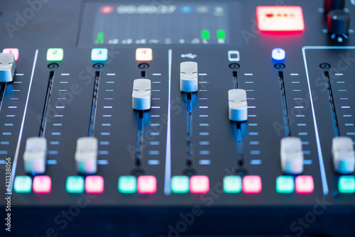 Professional podcast mixing console with faders and adjusting buttons, Audio sound mixer console. Sound mixing desk. Music mixer control panel in recording studio. podca mixer control broadcasting