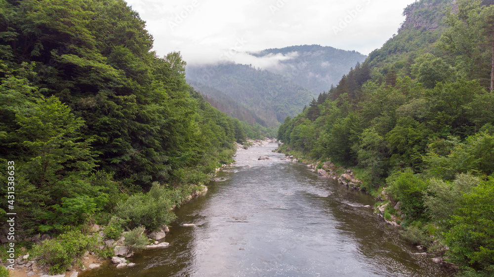 River stream on a green valley in an amazing and peaceful national park with fog and cloudy. Rural scenery mount and canyon in the balkan River stream on a green valley in an amazing and peaceful national park with fog and cloudy. Rural scenery mount and canyon in the balkan