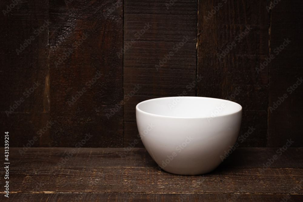 Empty White bowl ceramic on wooden background for graphic design. Empty White bowl ceramic on wooden background for graphic design.